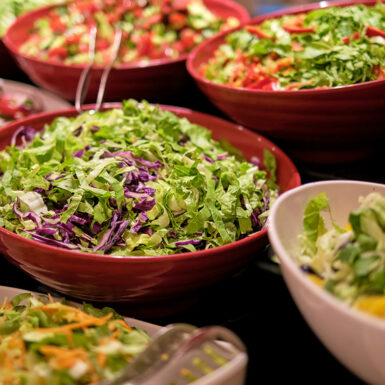 Vibrant salads with fresh veggies on display, shot close-up. The focus on fresh food caters to the trend of health and wellness.